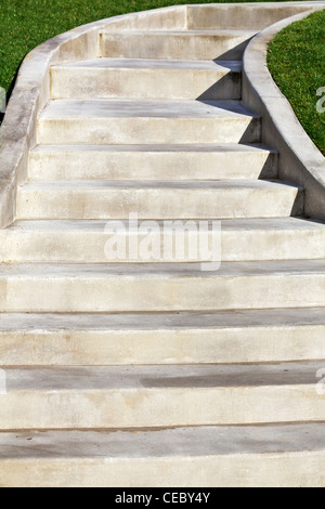 New Ascending Concrete Staircase with green grass on edges Stock Photo