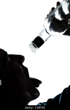 one caucasian man portrait silhouette drunk puring empty alcohol botlle in studio isolated white background Stock Photo