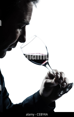 one caucasian man portrait silhouette smelling red wine glass in studio isolated white background Stock Photo