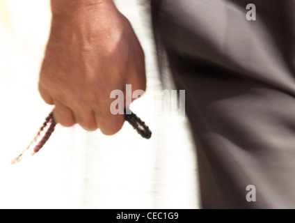 Close up of man's hand holding prayer beads Stock Photo