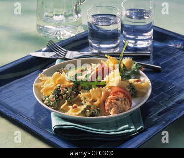 Farfalle salad with rucola - pesto and bacon - tuna rolls Stock Photo