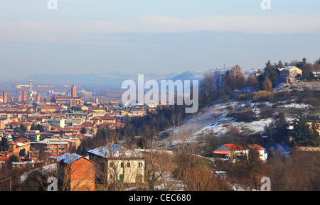 View on city of Alba and surrounding snowy hills in Piedmont, northern Italy. Stock Photo