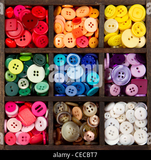 an assortment of buttons in a rainbow of colors, in a printers box Stock Photo