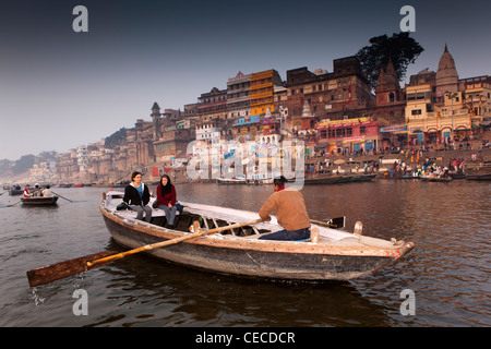 India, Uttar Pradesh, Varanasi, Ahil Yabai Ghat, tourists enjoying dawn rowing boat view of ghats in first light Stock Photo