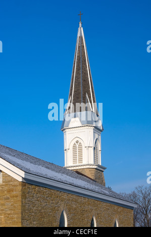 Church of Saint Peters steeple and chimneys under blue skies in Mendota Minnesota Stock Photo
