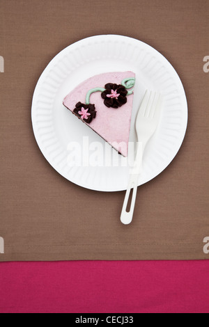 Slice of birthday cake on paper plate Stock Photo