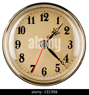 Classic style wall clock in shiny yellow metal frame, isolated on white background Stock Photo