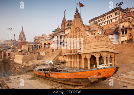 India, Uttar Pradesh, Varanasi, Scindia Ghat, Shiva temple sinking into banks of River Ganges Stock Photo