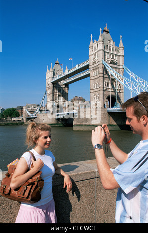 England, London, Young Tourist Couple taking Photos with Digital Camera in front of Tower Bridge Stock Photo