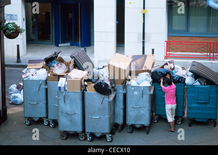 England, London, Overflowing Rubbish Collection Bins Stock Photo