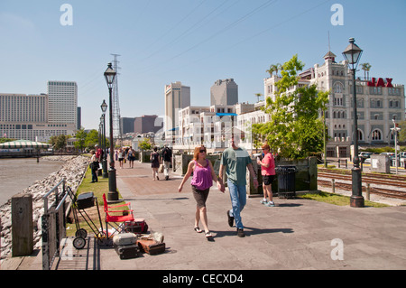 Couple walking along the Mississippi river and the Moon Walk near Jackson Square and the French Quarter in New Orleans Stock Photo