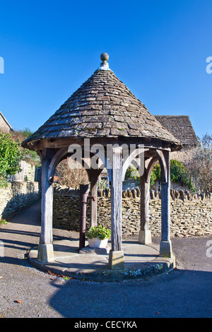 The old village water pump is the quaint English village emblem of Biddestone, Wiltshire, UK Stock Photo