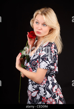 Young blonde woman with red rose. Stock Photo