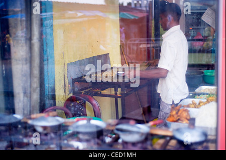 Cook preparing traditinial Sri Lankan fast food in Colombo. Colombo is the largest city and former capital of Sri Lanka Stock Photo