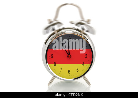 Ringing alarm clock with the German national flag, time set at five minutes to twelve, symbolic image for crisis in Germany Stock Photo