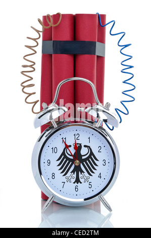 Time bomb, alarm clock with attached dynamite sticks and the Germany's Federal Eagle on its clock-face Stock Photo