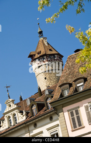 Vertical close up of the prominet old fortress, the Munot, visible behind old buildings in Schaffhausen on a bright sunny day. Stock Photo