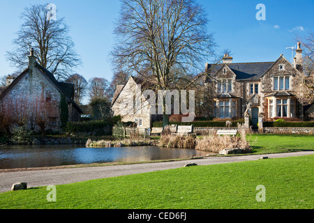 Houses around a typical English village duck pond on the green in Biddestone, Wiltshire, England, UK Stock Photo