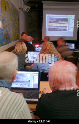 Lecture on photography; group working on laptops Stock Photo