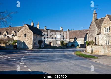 A country road through the Cotswold village of Biddestone, Wiltshire, England, UK Stock Photo