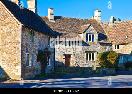 Typical Cotswold stone houses along the road through the English village of Biddestone, Wiltshire, England, UK Stock Photo