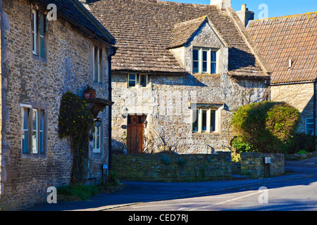 Typical Cotswold stone houses along the road through the English village of Biddestone, Wiltshire, England, UK Stock Photo