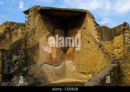 The ruins of a building still showing remnants of plaster decorated in the fourth style with colourful architectural motifs Stock Photo