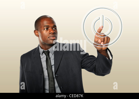 African American businessman touching power button Stock Photo