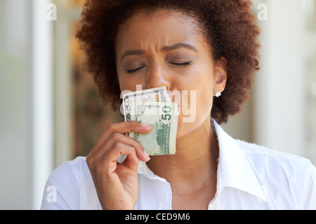 African American woman kissing 50 dollar bill Stock Photo