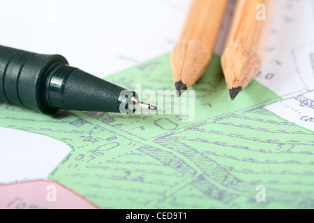Pencils and marker on a topographic map Stock Photo