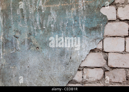 Brick wall with fallen off plaster Stock Photo