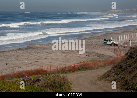 Border Patrol Agent on Beach at Pacific Ocean Stock Photo