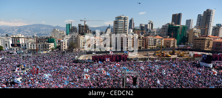 Up to a million people fill Martyrs Square in Beirut, Lebanon. Snow-capped mountains seen beyond city-centre towers Stock Photo