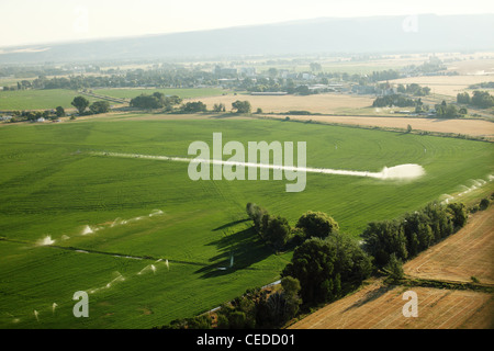 An aerial view of farmland and pivot sprinklers watering the fields. Stock Photo