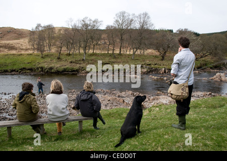 People watching fishermen on the bank of the River Oykel, Sutherland, Scotland, UK Stock Photo