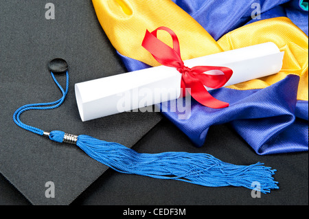 A graduation setting with cap,tassel, gown, hood and diploma. Stock Photo