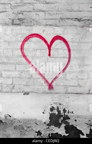 A heart shape spray-painted on to a brick wall in an alleyway in Derby, UK Stock Photo