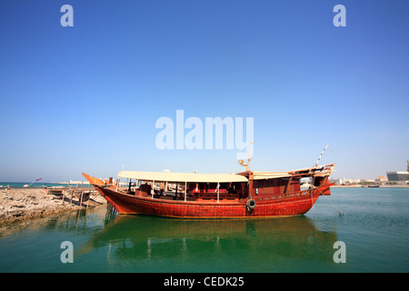 Traditional wooden fishing boats known as Dhow's moored in Doha harbour Stock Photo