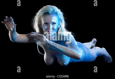 mystic mermaid theme showing ablue bodypainted woman in black back