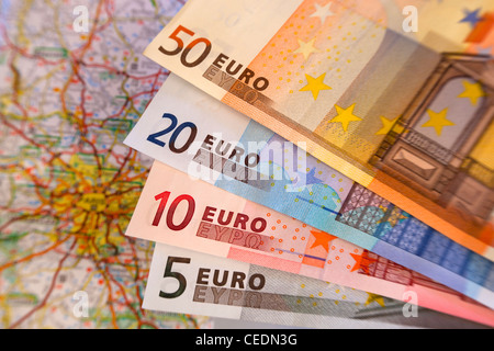 Fan of different size Euro notes currency with map in background Stock Photo