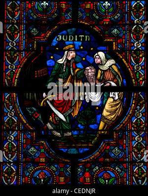 Judith Beheading Holofernes, stained glass window in the church of Dinant, Stock Photo