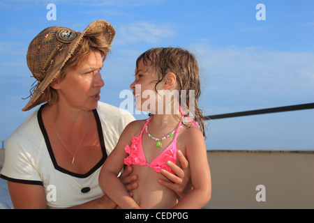 mature woman with little girl on veranda Stock Photo
