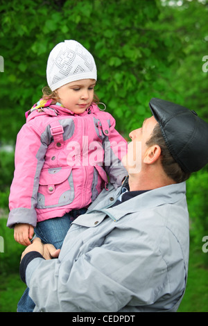 man lifts little girl Stock Photo