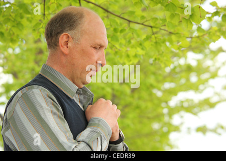 portrait of middle-aged  praying  man outdoor Stock Photo