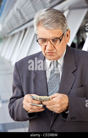 Senior man counting money Stock Photo