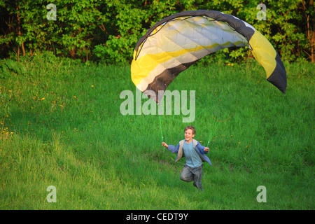 boy and parachute near the ground Stock Photo