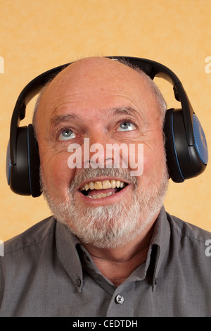 Elderly man with headphones, happy Stock Photo