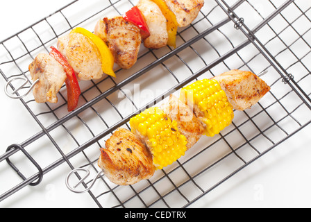 Chicken skewers on a grilling grid Stock Photo