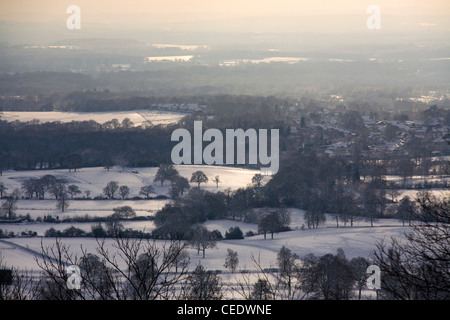 Snow covered fields and forests of Surrey shot from the top of Holmbury Hill, Surrey Hills. UK Stock Photo