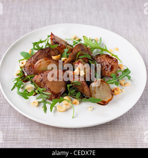 Chicken livers with shallots and rocket Stock Photo